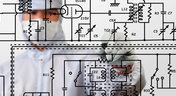 Man beside electrical schematic